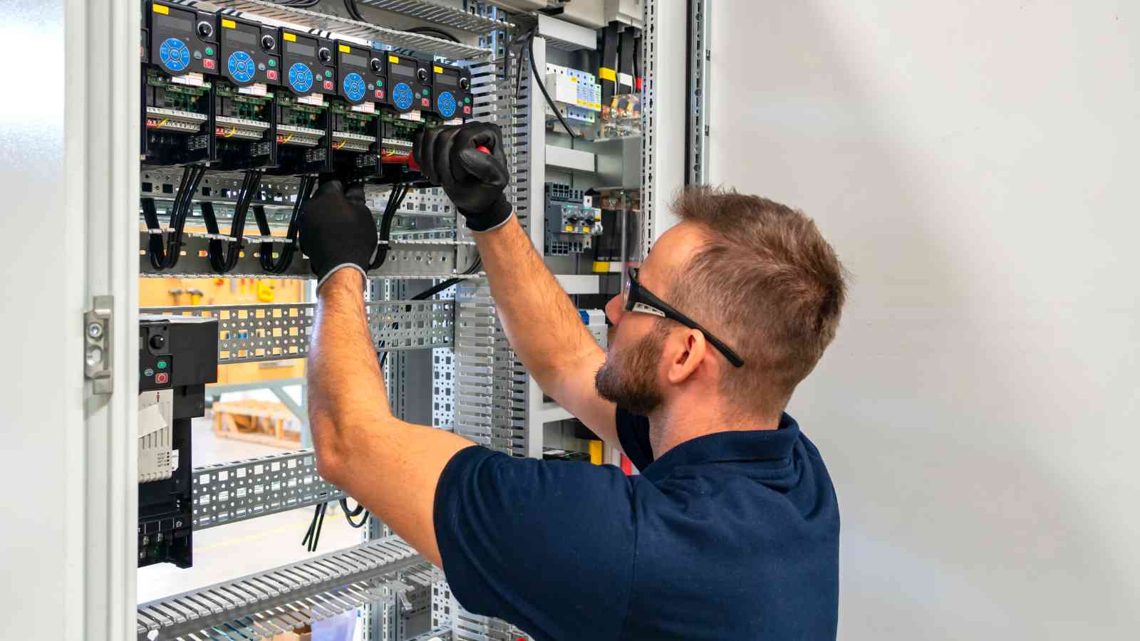 Qualified electrician working on industrial electrical systems