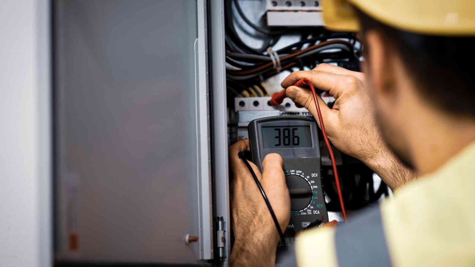 Electrician diagnosing an electrical fault with a multimeter